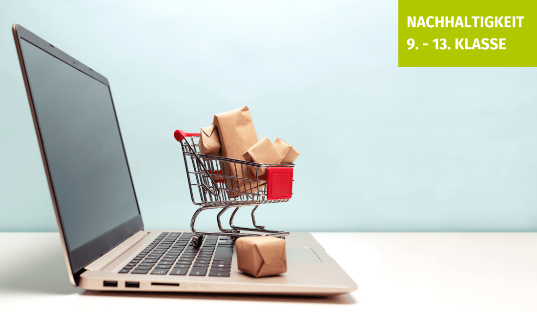 Ein aufgeklappter Laptop mit einem kleinen, vollen Einkaufswagen auf der Tastatur