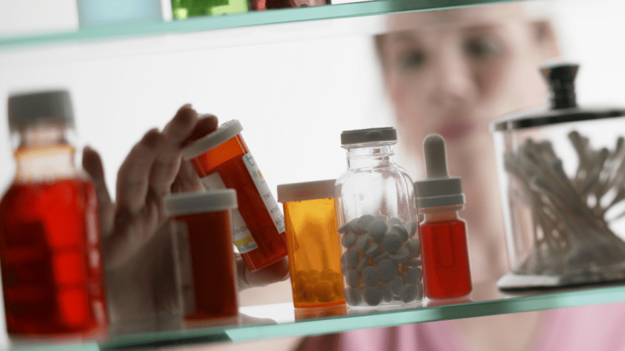 Blick in einen Glasschrank mit Tablettenbehältern